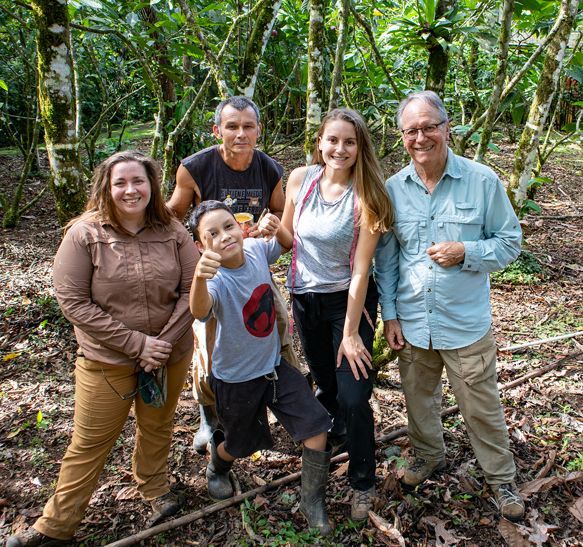 A team of volunteers takes a break in the rainforest
